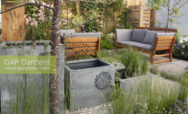Decorative water butts as water feature in #knollingwithdaisies garden at RHS Hampton Court Palace Garden Festival 2022