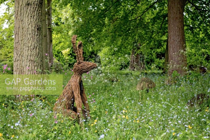 Hare Willow Sculpture, designed by artist Emma Stothard, sits on the edge of the Stumpery, May, 2022.