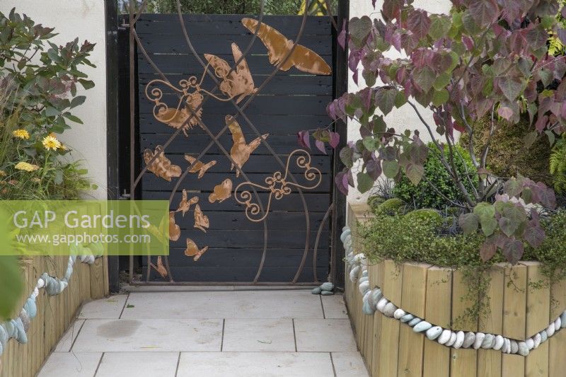Decorative metal gate panel in the Metamorphosis garden at BBC Gardener's World Live 2022