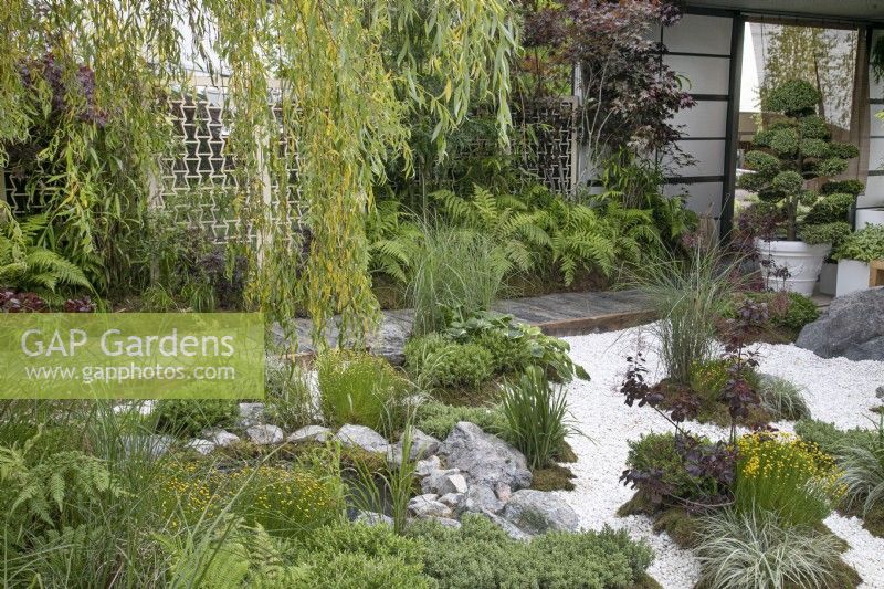 Railway sleeper path, bordered by white stone chippings in The Lexus Kansho-niwa Experience garden at BBC Gardener's World Live 2022