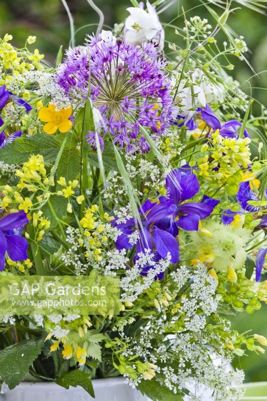 Spring flower bouquet containing allium, iris, wild flower perennials and grasses.