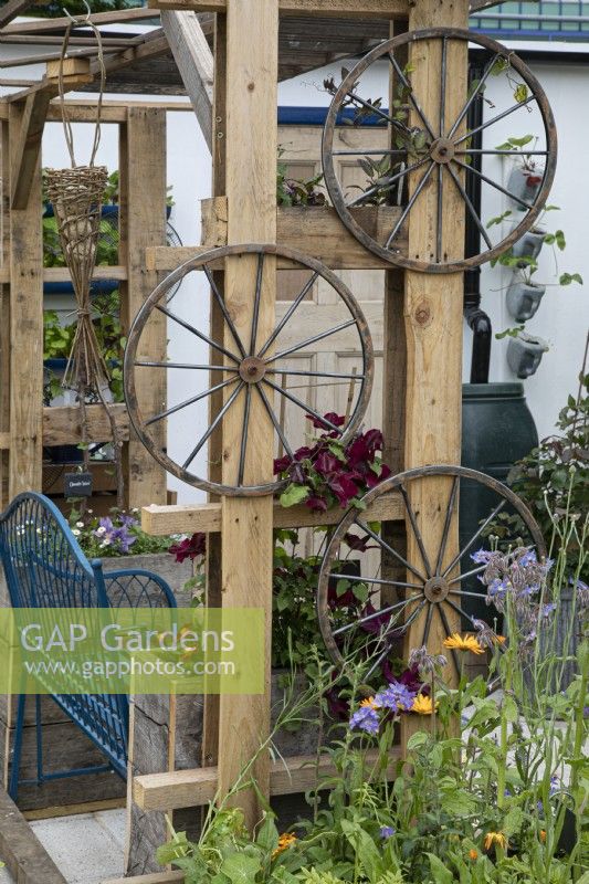 Recycled pergola with seating area in the Small Space - Big Ideas show garden at BBC Gardener's World Live 2022