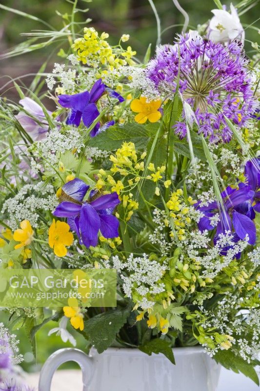 Spring flower bouquet containing allium, iris, wild flower perennials and grasses.