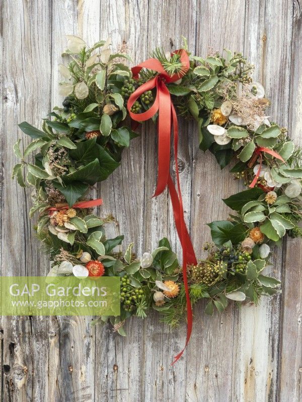 Completed Christmas wreath with fresh foliage and dried seed heads
