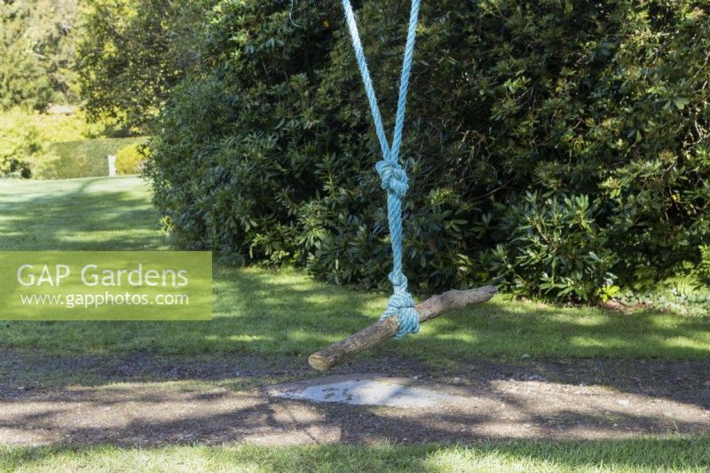 A rope swing using a piece of wood. Regency House, Devon NGS garden. Autumn