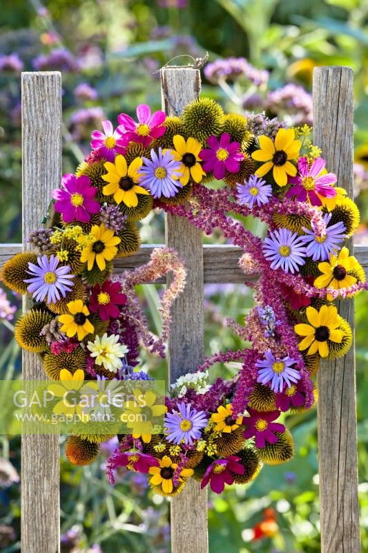 Summer flower wreath made of comos, rudbeckia, amaranthus, aster, echinacea and verbena.