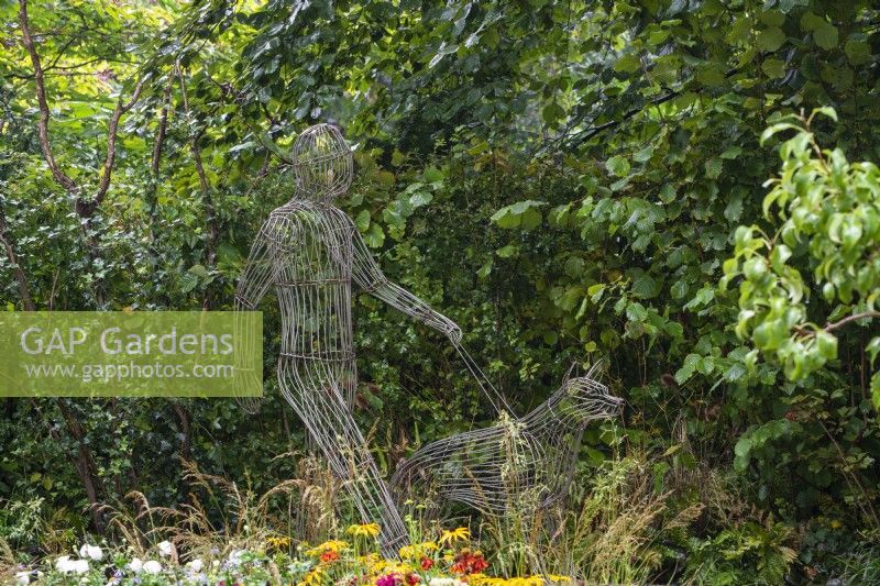 Wire man and dog sculpture by Tom Hill - Guide Dogs 90th Anniversary Garden, RHS Chelsea Flower Show 2021