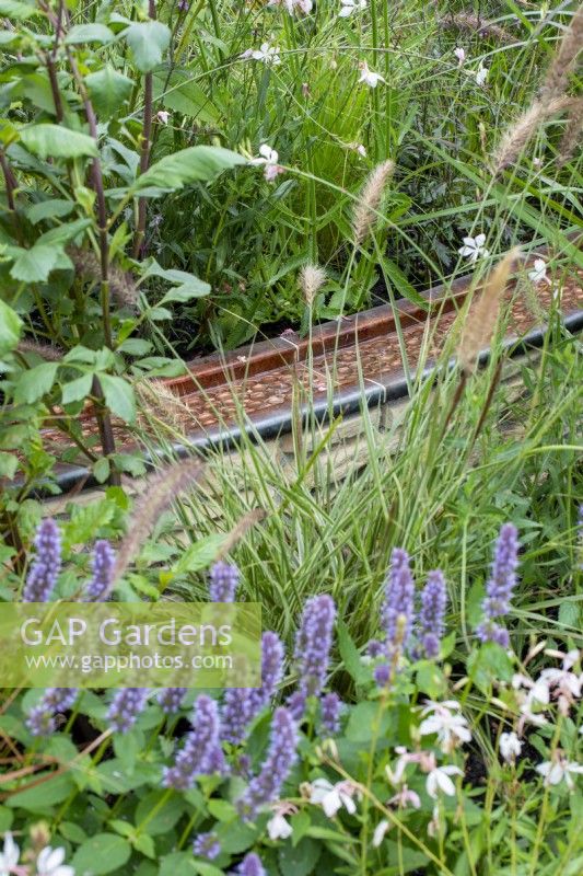 Copper water rill winding through planting - Finding Our Way: An NHS Tribute Garden, RHS Chelsea Flower Show 2021