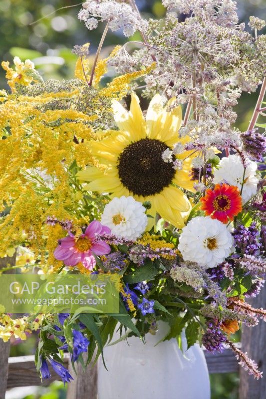 Summer flower bouquet containing dahlia, sunflower, zinnia, goldenrod and verbena.