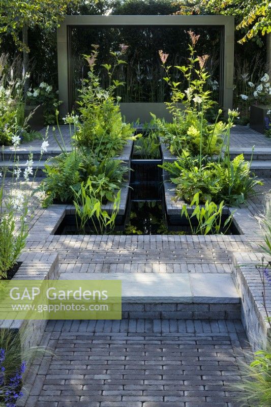 Water feature rill in hard landscaping -Macmillan Legacy Garden: Gift the Future garden at  RHS Hampton Court Palace Garden Festival 2022