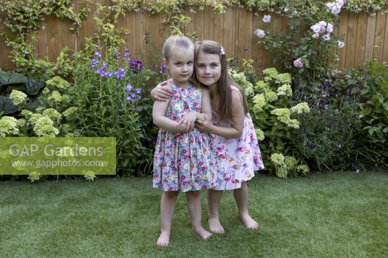 Two young girls playing in a garden