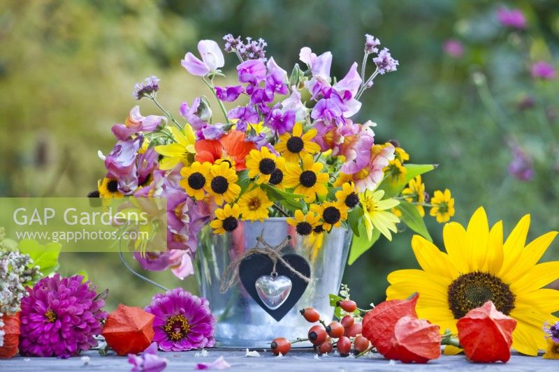 Floral arrangement with rudbeckia, sunflower and sweet peas.