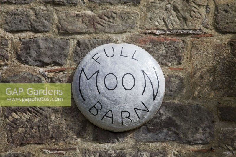 Full Moon Barn  house light sign on the rustic stone wall