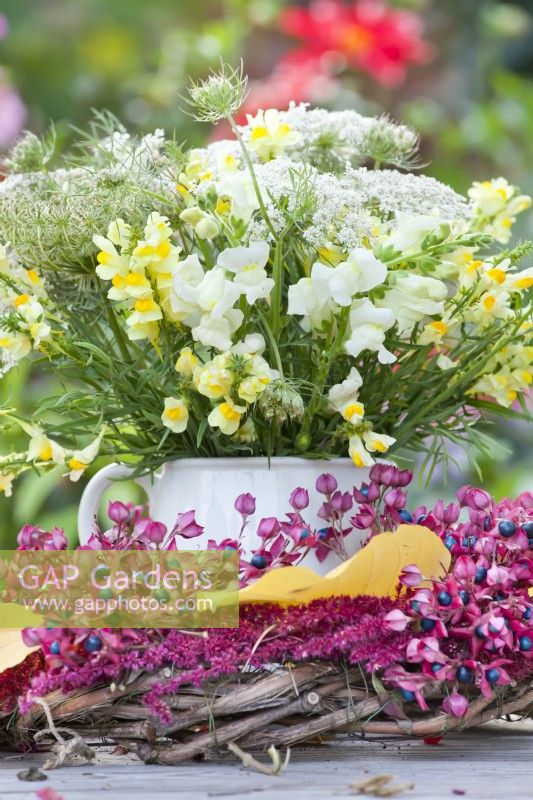 Yellow - white themed bouquet with Antirrhinum and wild carrots.