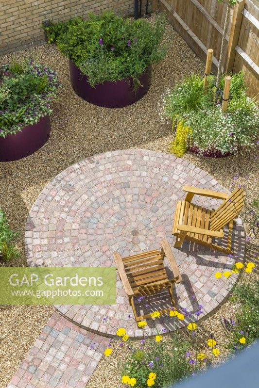 Overhead view of a modern low-maintenance garden with circular paving feature. June