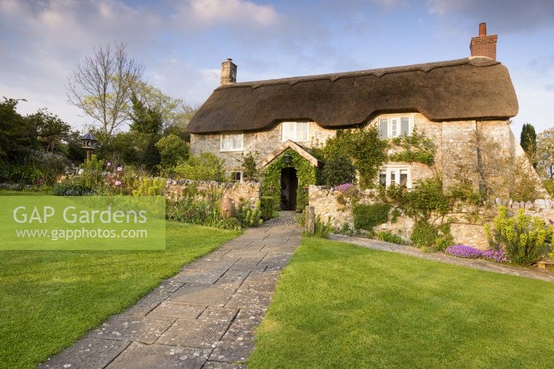 Thatched cottage in a country garden in April
