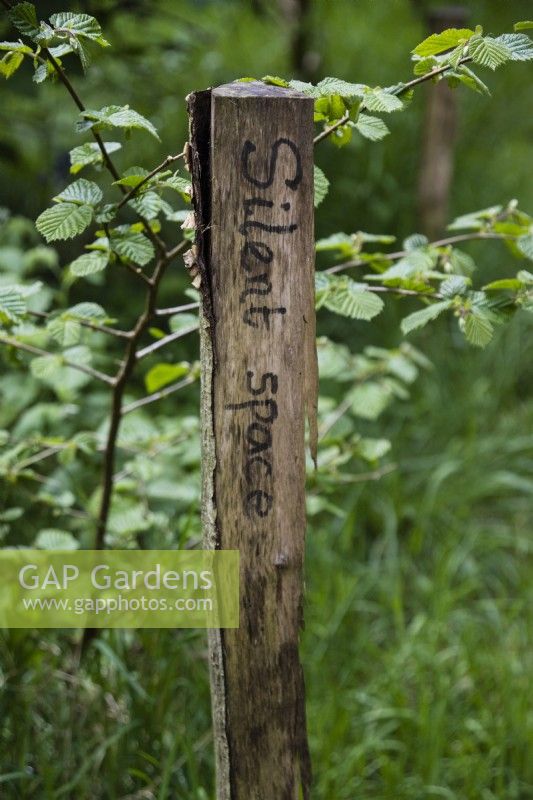 Sign designating 'Silent Space' on wooden post. 