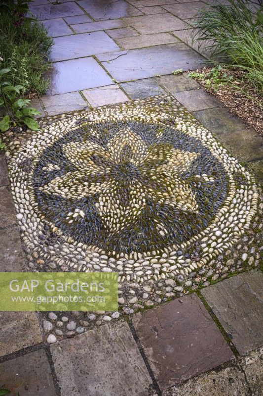 Pebble mosaic set into a terrace at Ellicar gardens.