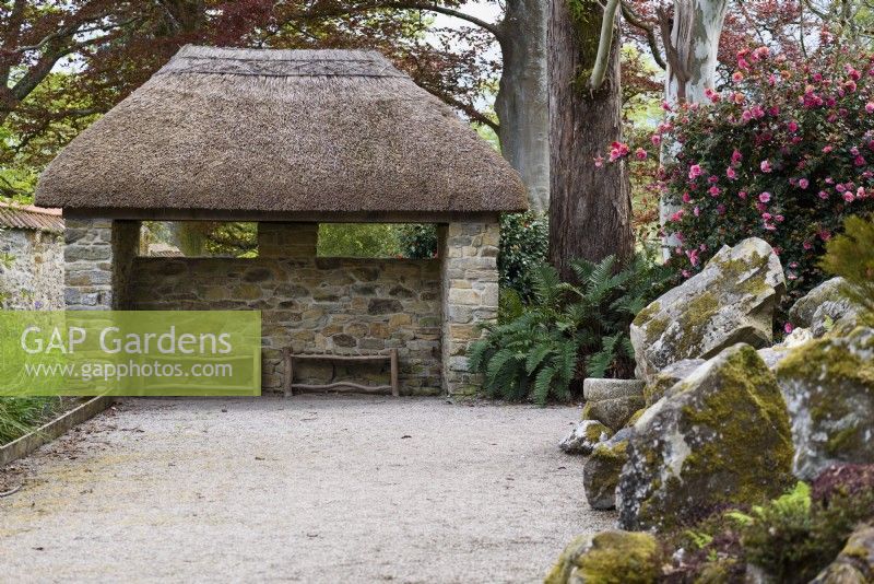 Thatched pavilion at Enys garden, Cornwall in May