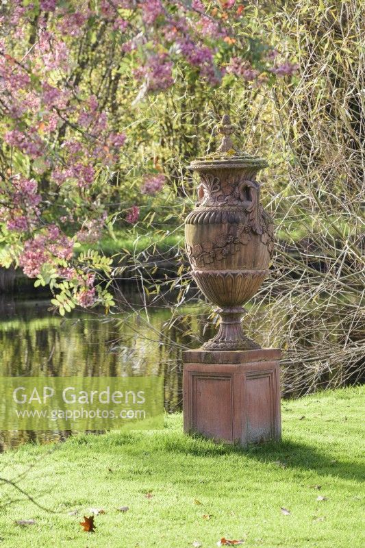 Decorative terracotta urn beside the canal in John Massey's garden in October.