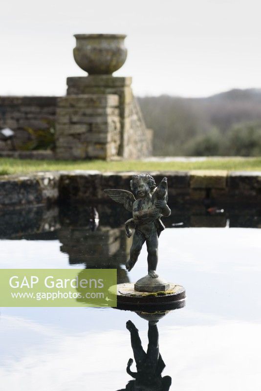Putto in the lily pond at Cotswold Farm Gardens in February.