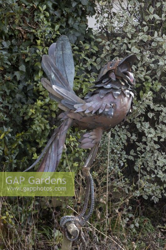 Doug 2, a bird sculpture on an old wooden tool handle. Made by Michael Kusz out of recycled metal. February. 