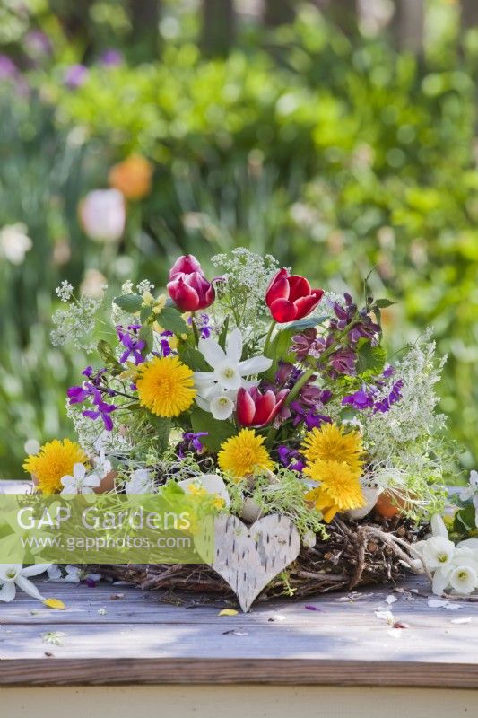 Spring floral arrangement with tulips, daffodils, dandelion, cow parsley, honesty and deadnettle.