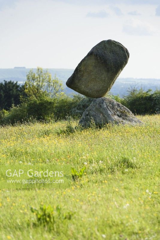 Stonebalancing sculpture by Adrian Gray in a Wiltshire garden in May