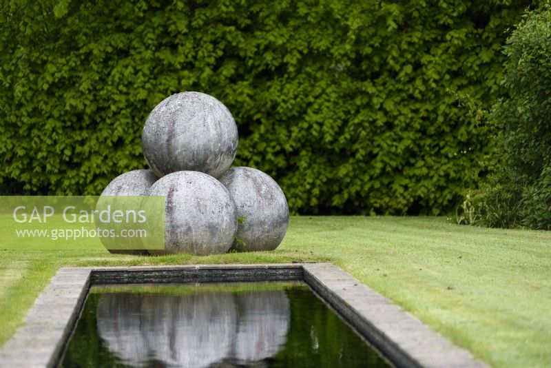 Stone spheres at the end of a rectangular pond