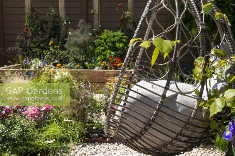 Egg-shaped swing seat with cushions- The Chic Garden Getaway - BBC Gardeners' World Live 2023 - Designer: Katerina Kantalis