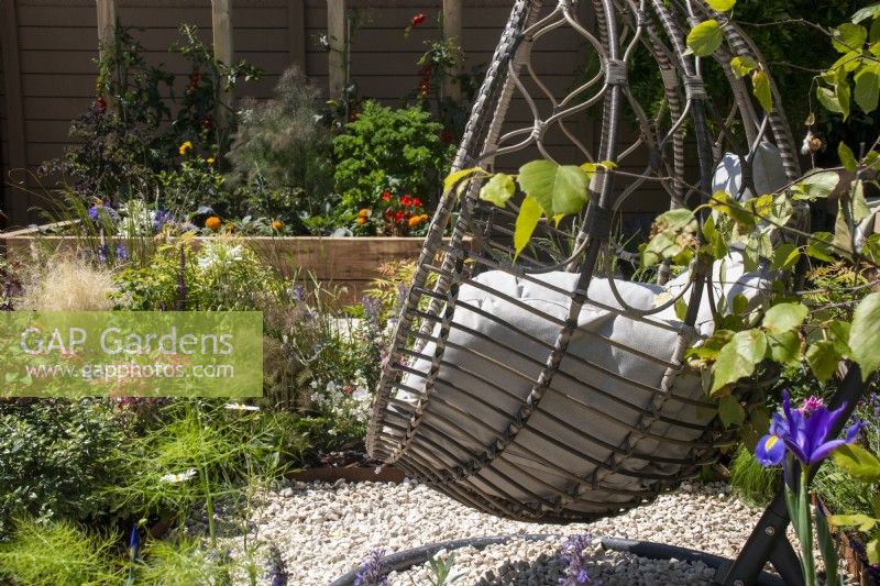 Egg-shaped swing seat with cushions- The Chic Garden Getaway - BBC Gardeners' World Live 2023 - Designer: Katerina Kantalis