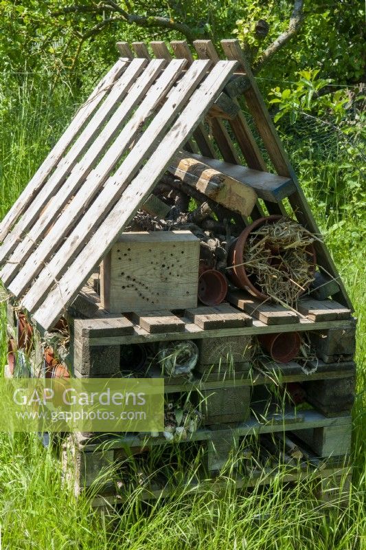 Insect and wildlife shelter built from wooden pallets with various materials inside to provide protection - Open Gardens Day, Shelfanger, Norfolk  
