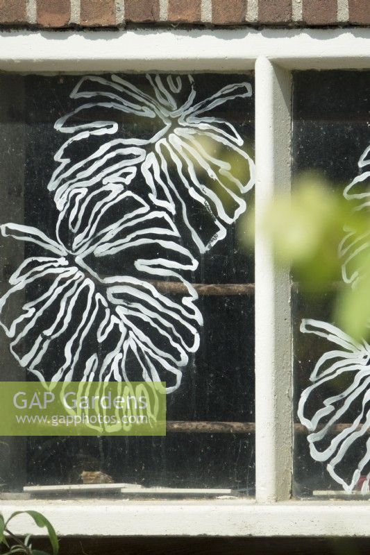 Painted leafs as decoration idea on old farm windows.