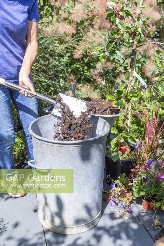 Woman placing compost in the bin