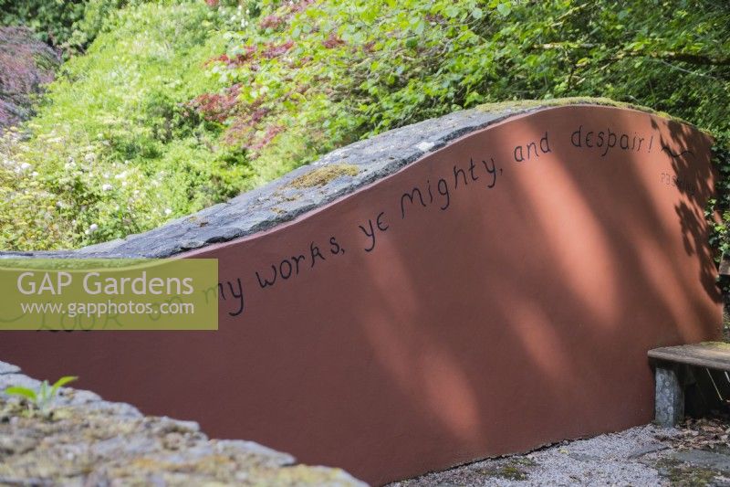 Inscription of part of Ozymandius by Shelly on painted wall in garden. June. Summer. 