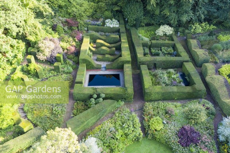 Wide view over the garden with Yew hedges containing several other garden rooms. September. Image taken with drone. 