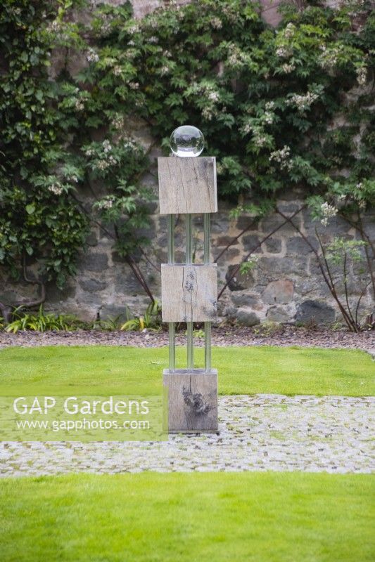 Sculpture of wooden blocks and Perspex rods mounted with glass globe by Robert Dalrymple in the Upper Courtyard. August.