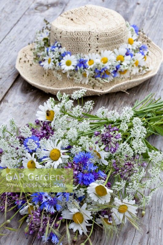 Wildflower bouquet containing daisies, wild carrots, alliums and cornflowers.
