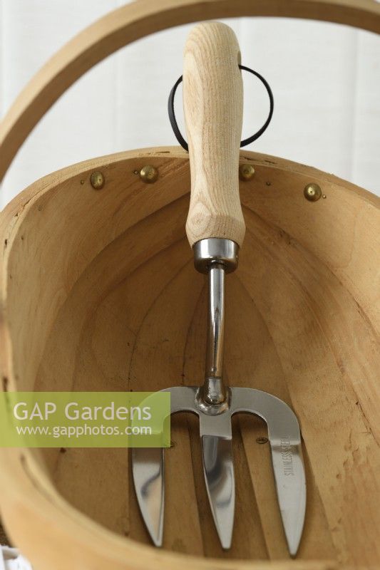 Gardening hand tool in wooden trug  May