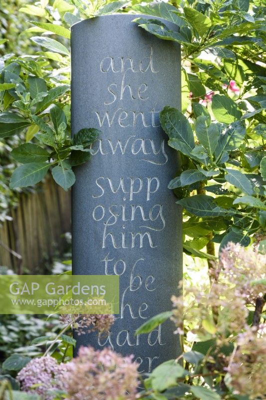 Slate with inscribed lettering in a summer garden