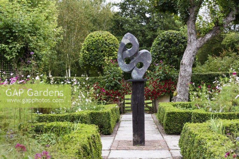 Great Responsibility by Antony Masamba forms a central focus in the parterre garden at Falkners Cottage in September