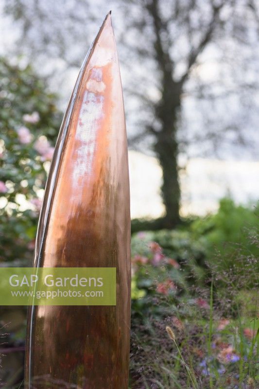 Reflective copper surface of Seed Pod by Ted Edley in a garden in September