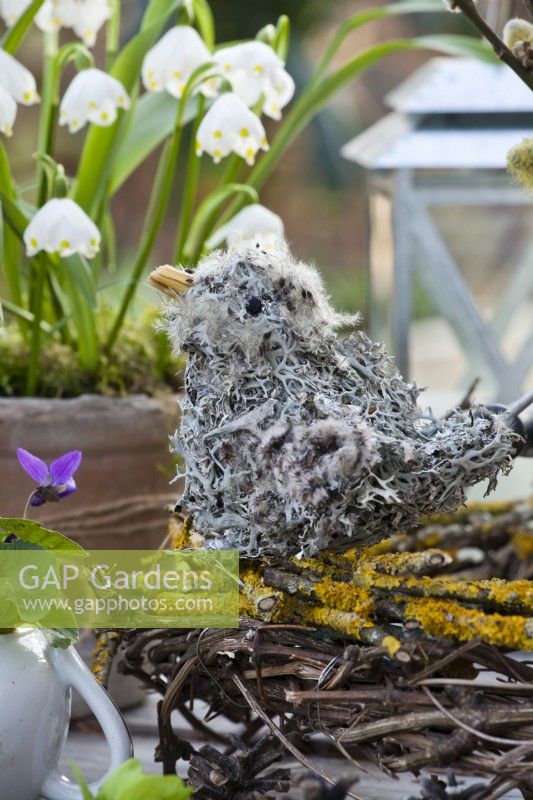 A bird made of lichens and clematis seedheads in the nest.