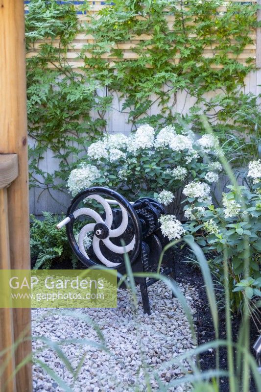 Decorative metal crank in garden corner