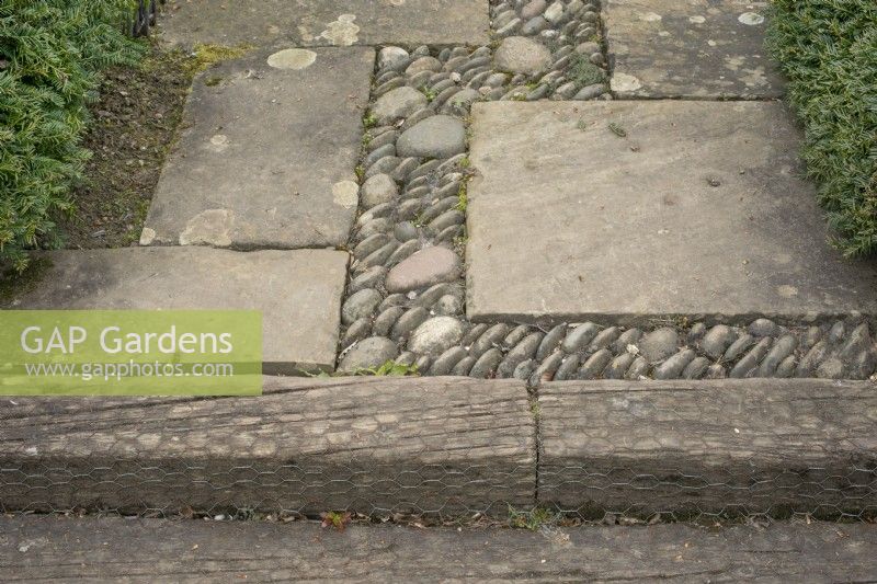 Paving in the Reclaimed Garden, edged with railway sleepers covered in chicken wire to make them less slippery. Barnsdale Gardens, April