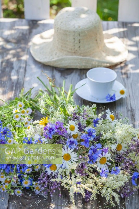 Summer flower bouquet containing daisies, cornflowers, tall fleabane and Persicaria.