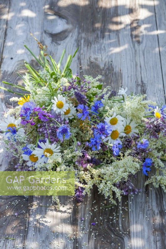 Summer flower bouquet containing daisies, cornflowers, tall fleabane and Persicaria.