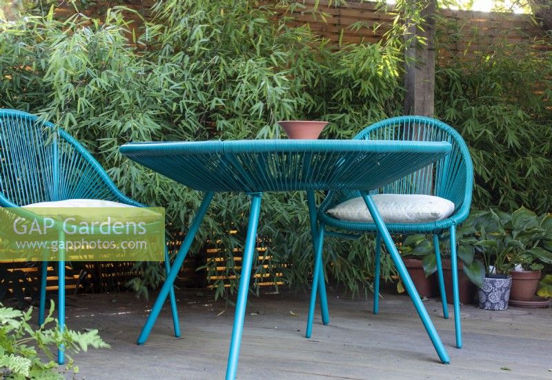 Bright blue furniture adds colour to the garden at April House, Gloucestershire 