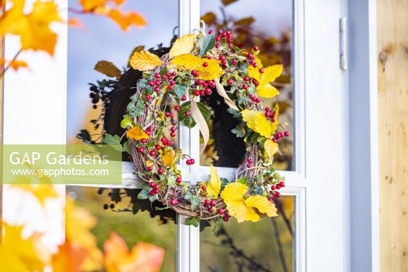 Wreath made up of Ivy, Beech sprigs and Hawthorn hanging from door