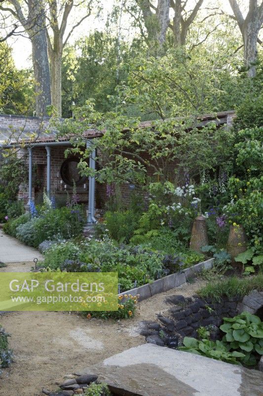 View of the vegetable garden in The Savills Garden with clay forcing pots - Designer: Mark Gregory - Sponsor: Savills -